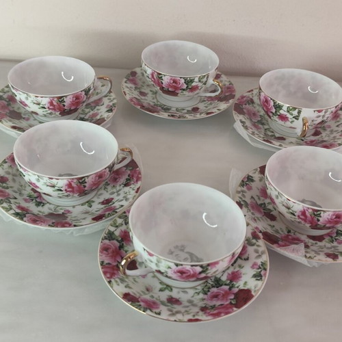 Vintage porcelain tea cups set with floral rose pattern and lithophany