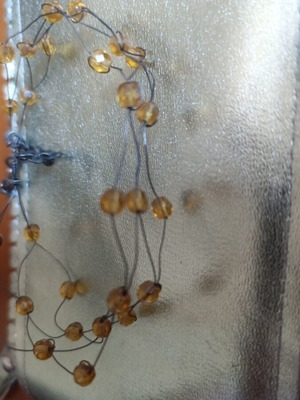 Necklace with yellow beads and wire used, choker style