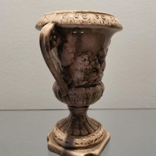Faience amphora used with embossed design and cupids