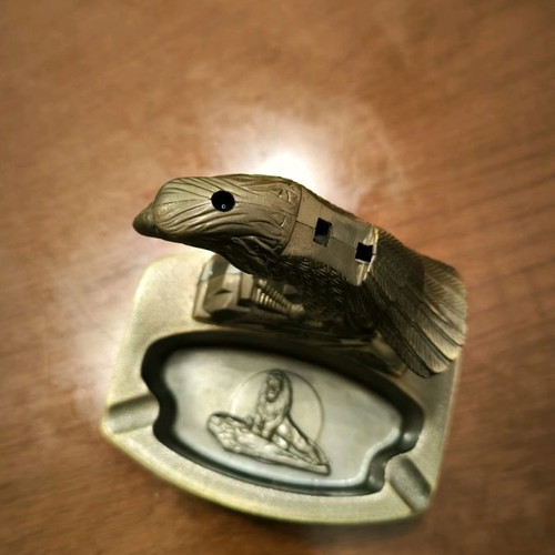 Metal ashtray lighter with two cigarette slots and plastic bird