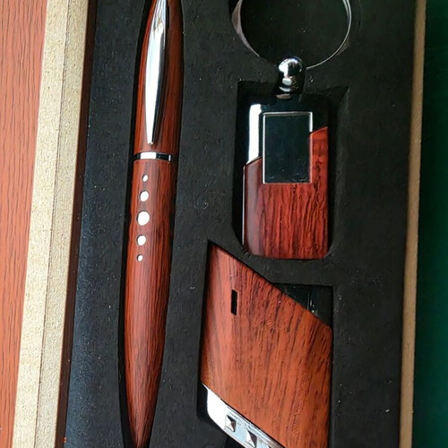 Set of three gifts in luxury wooden box with pen, lighter and keychain