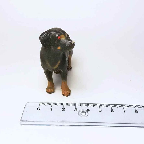 Plastic dog figure used with scratches and marks