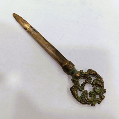 Vintage brass letter opener with embossed baroque handle, used