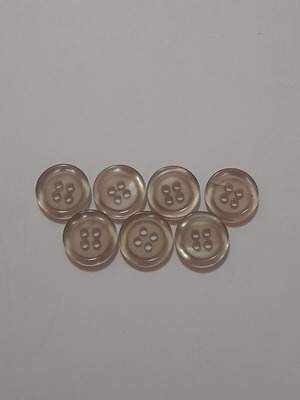 Set of 7 light gray semi-transparent buttons with 4 holes