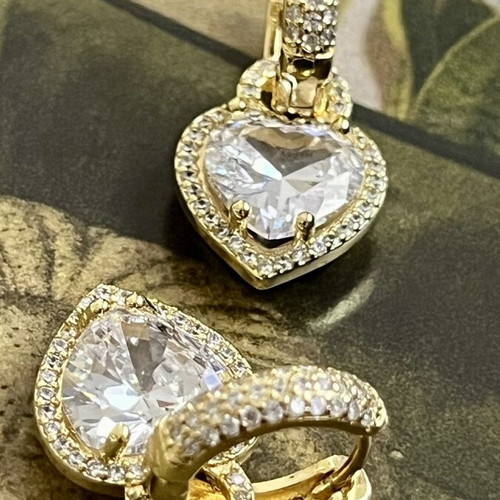 Gold-tone earrings with heart-shaped transparent stone and zircon details