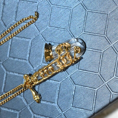 Swarovski necklace with saxophone pendant and crystal like new, gold plated