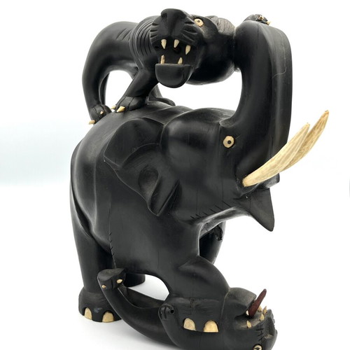 Vintage handmade ebony wood sculpture of elephant and lions