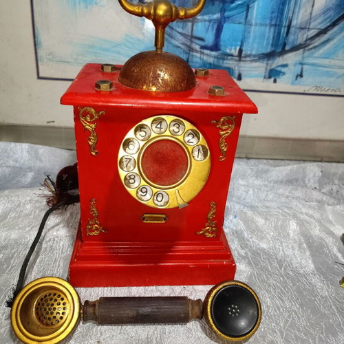 Vintage metal rotary phone, red with gold details