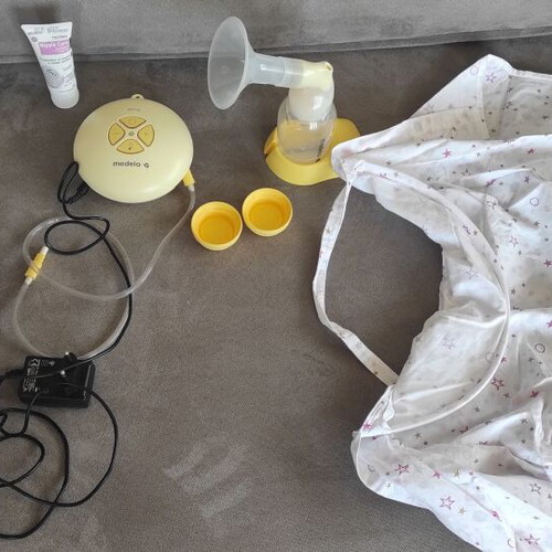 Mendela Swing breast pump used with nursing cover