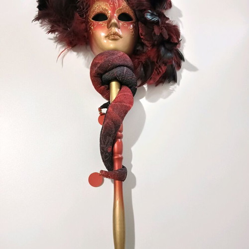 Mask with handle used, burgundy shades with minor wear