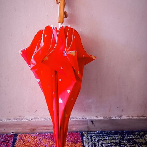 Children's umbrella red with patterns used