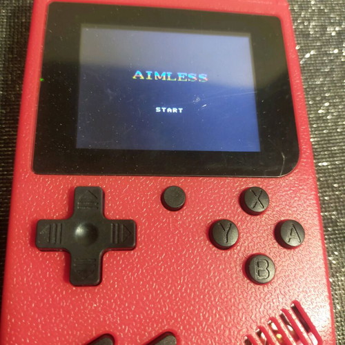 Retro style handheld game console used, working