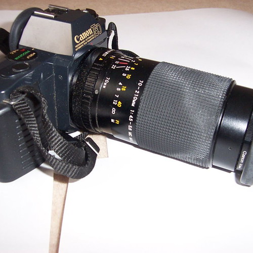 Canon T50 SLR analog camera used with two zoom lenses and flash
