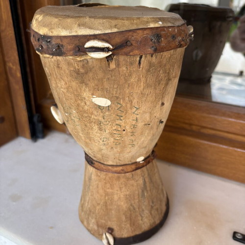 Handmade wooden drum used, African style with leather membrane and shells