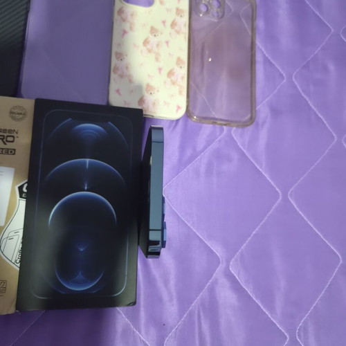 iPhone 12 Pro Max Pacific Blue 128GB like new with 7 cases and screen protectors