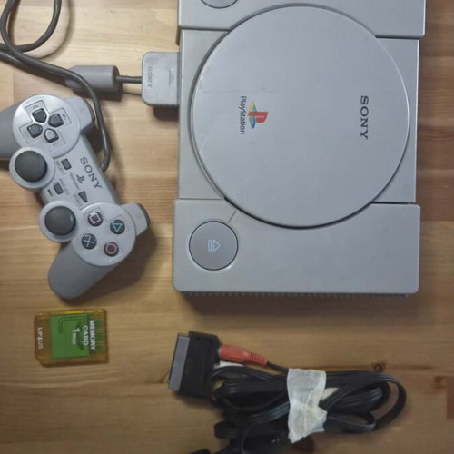 Sony PlayStation 1 console used with memory card, controller, and game