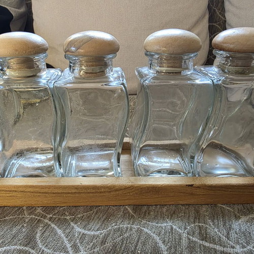 Set of 4 glass jars with wooden lids and wooden base like new