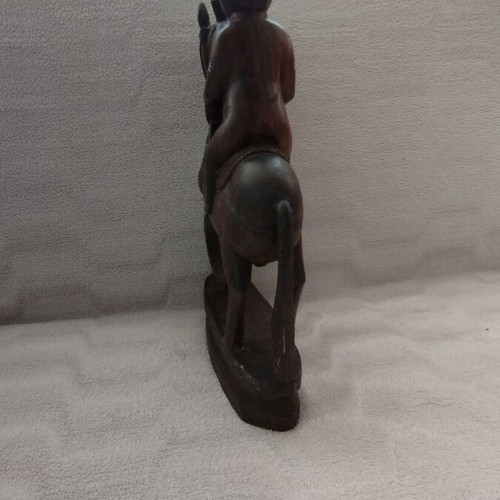 Wooden carving of South Indian man riding horse used