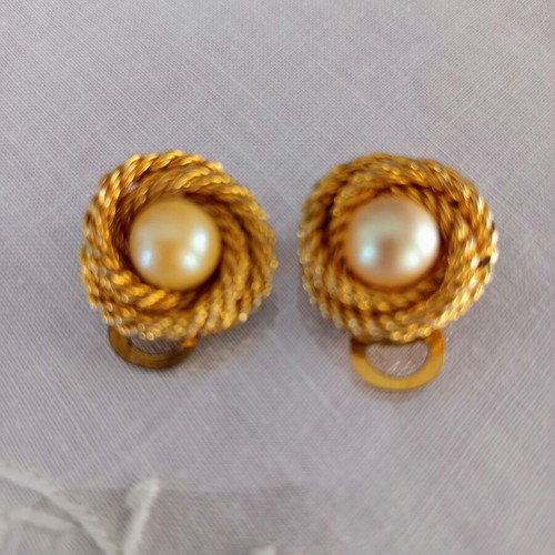 Vintage clip-on earrings used with gold embossed design and white pearl