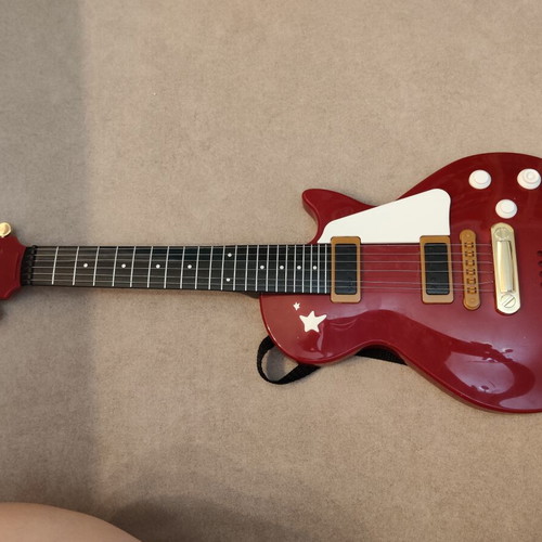 Toy guitar for small children, musical buttons