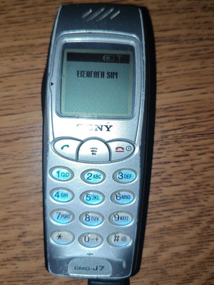 Sony j70 cell phone used, silver, with charger and removable battery