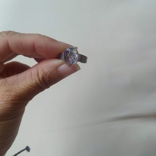 Floral ring handmade with lilac flowers in epoxy resin