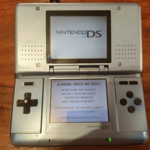 Nintendo DS console with charger and stylus