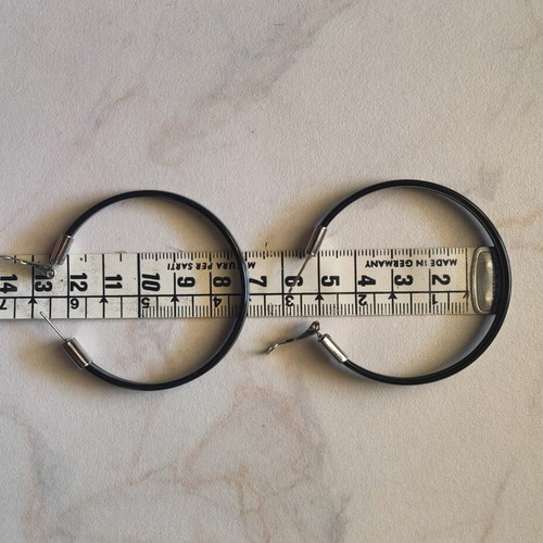 Large black hoop earrings used with silver details