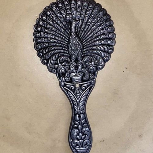 Handheld toilet mirror used with embossed peacock design