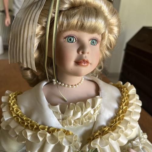 Porcelain doll sitting with curls, vintage