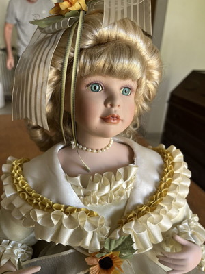 Porcelain doll sitting with curls, vintage