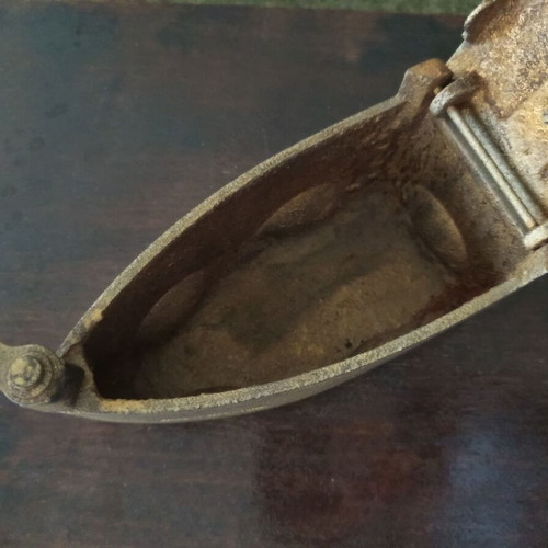 Decorative old charcoal iron refurbished with gold varnish