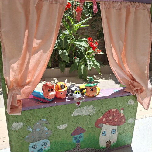 Handmade wooden puppet theater with hand-painted details and puppets like new