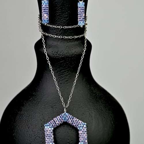 Custom-made jewelry set in light blue tones with hexagonal pendant