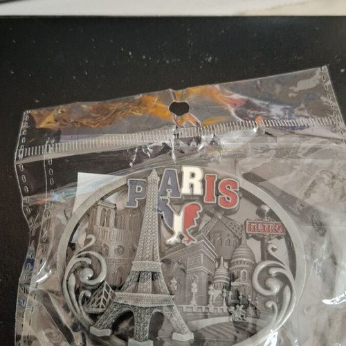 Metal souvenir magnet with Paris theme, silver color