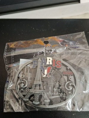Metal souvenir magnet with Paris theme, silver color