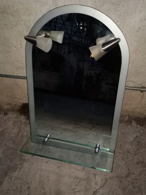 Semi-circular bathroom mirror used with 2 lights and shelf
