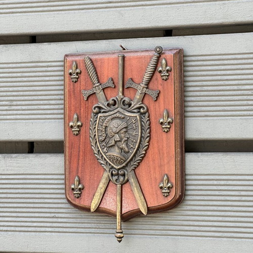 Vintage wooden wall shield with metal coat of arms, swords & fleur-de-lis used