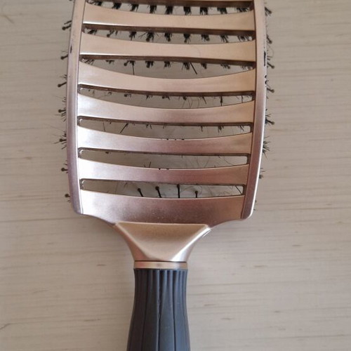 Hair comb with short bristles and openings