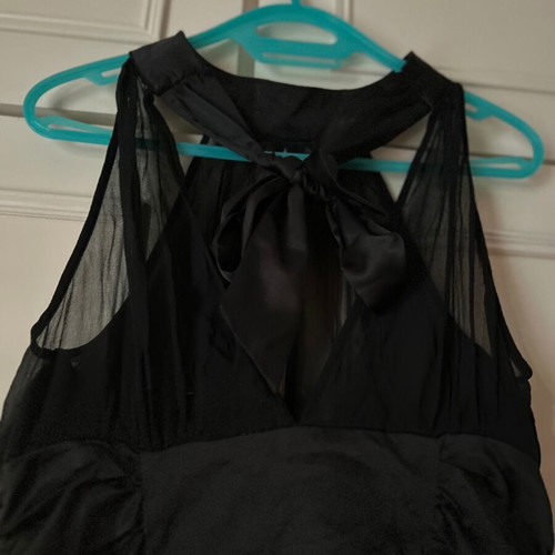 Twentyone L, women's black blouse, made of satin and muslin. The bow at the back.