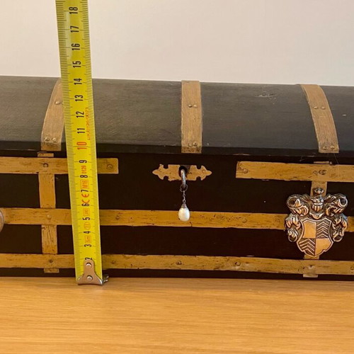 Antique wooden chest used with medieval emblem