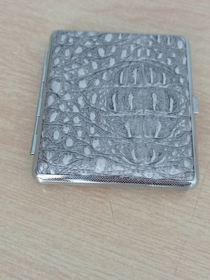 Metal cigarette case like new with embossed leather texture
