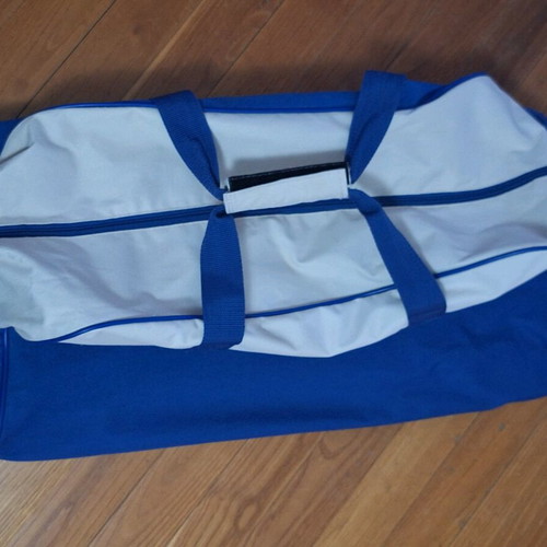 Travel sack used with handle and wheels, beige and blue