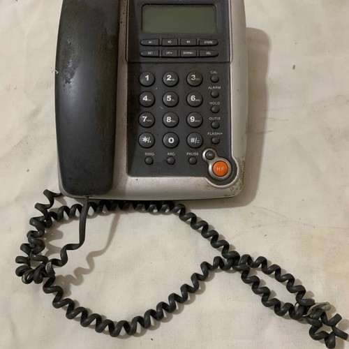 Landline phone old type used, gray, wired