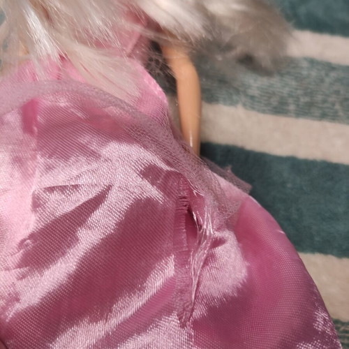 Barbie doll used with dress tears