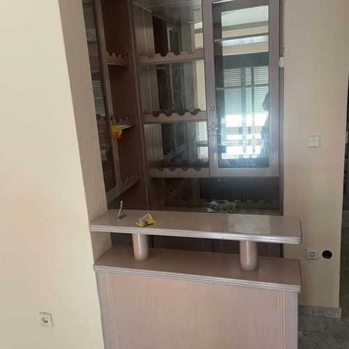 Mini bar like new with mirrors, cabinets, and carpeted floor