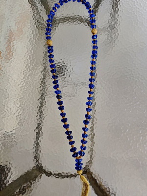 Tabletop komboloi with blue and gold glass beads