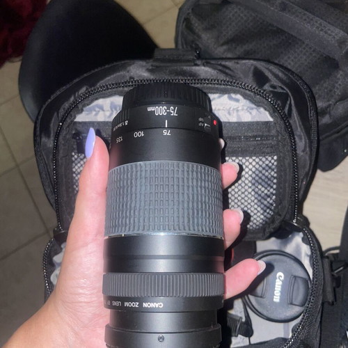 Canon EOS 1200D camera kit with lenses, memory card, battery, charger, and carrying bag