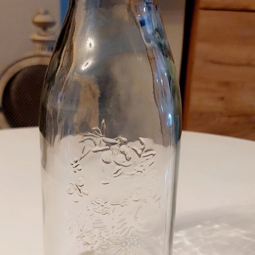 Glass bottle Frutta del Prato like new with embossed floral design