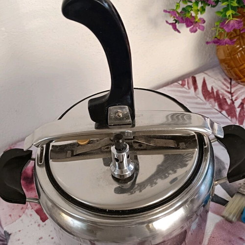 Pressure cooker used, old style, stainless steel with safety lid